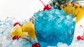 Blue cocktail with ice, cherry, and pineapple garnish Royalty Free Stock Photo