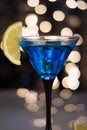 Blue cocktail in martini glass with slice of lemon Royalty Free Stock Photo