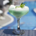 Blue cocktail in a beautiful glass with ice cream and green mint Royalty Free Stock Photo
