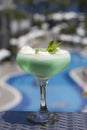 Blue cocktail in a beautiful glass with ice cream and green mint Royalty Free Stock Photo