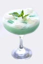 Blue cocktail in a beautiful glass with ice cream and green mint Royalty Free Stock Photo