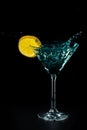 Blue cocktail water drink splash in the glass with lemon Isolated on black Royalty Free Stock Photo