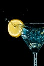 Blue cocktail water drink splash in the glass with lemon Isolated on black Royalty Free Stock Photo