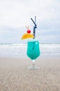 Blue coctail in the glass on the sea background