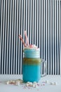 Blue coffee with cream, marshmallow and colorful decoration on a black-and-white background. Milk shake. Unicorn coffee Royalty Free Stock Photo