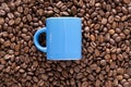Blue coffee cup on coffee beans Royalty Free Stock Photo