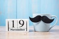 Blue coffee cup, Black mustache and 19 November Calendar. in the morning. Father, International men day, Prostate Cancer