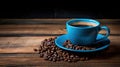 A blue coffee cup full of black coffee on a wood background with coffee beans Royalty Free Stock Photo