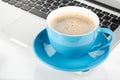 Blue coffee cup and laptop Royalty Free Stock Photo