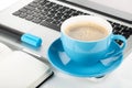 Blue coffee cup, laptop and office supplies Royalty Free Stock Photo