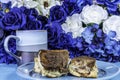 Coffee and sticky buns on blue with blue flowers