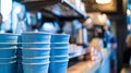 Blue coffee cups stacked in a cozy cafe setting