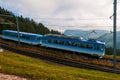 Blue cogwheel train on Rigi Mountain, Swiss Alps Royalty Free Stock Photo