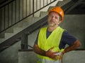 Blue collar job lifestyle. Portrait of tired and exhausted construction worker in helmet and vest at building site complaining of Royalty Free Stock Photo