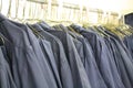 Blue collar work shirts uniforms on hangers