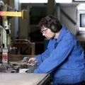 Blue collar worker cleaning machine Royalty Free Stock Photo