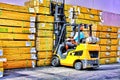 Blue Collars finistest fork lift driver grabs another stack of lumber Royalty Free Stock Photo