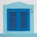 Blue colonial window on a wall