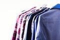 Blue color clothes. Male clothes, jackets and shirts hanging on clothes rail. Copy space. Banner Royalty Free Stock Photo