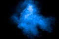 Blue color dust particles explosion cloud on black background.Color powder splash Royalty Free Stock Photo