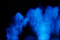 Blue color dust particles splash cloud on black background.Color powder explosion Royalty Free Stock Photo