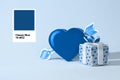 Blue color gift box and heart on light blue background in minimal classic style. Creative concept