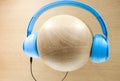 Blue color headphones display on wood ball view