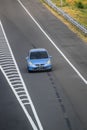 Blue color Honda jazz or Honda fit driving fast on trans jawa highway blurry in motion Royalty Free Stock Photo
