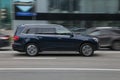 Blue color Mercedes-benz GLS Class in fast motion on the street, side view