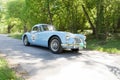 Blue color MG MGA classic car from 1957 driving on a country road