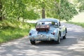 Blue color MG MGA classic car from 1957 driving on a country road