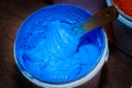 blue color of plastisol ink in white plastic barrel.