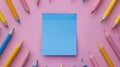 A blue color post it paper, pink, blue and yellow pencils on pastel pink background. Royalty Free Stock Photo