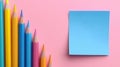 A blue color post it paper, pink, blue and yellow pencils on pastel pink background. Royalty Free Stock Photo