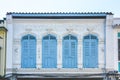 Blue color wooden arched window on white cement wall in chino Portuguese style at Phuket old town, Thailand Royalty Free Stock Photo