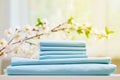 Blue colored bed sheets on the dresser. Blurred background. Flowering branch Royalty Free Stock Photo