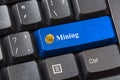 Blue colored Bitcoin Mining button on black computer keyboard. Crypto currency Internet data privacy information security concept. Royalty Free Stock Photo