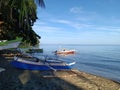 Blue colored of fishing boat, sky and water on the beach