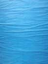 Blue colored glued paper forming a pattern of waves