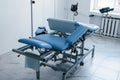 Blue colored obstetric bed indoors in the clinic cabinet at daytime