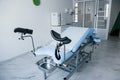 Blue colored obstetric bed indoors in the clinic cabinet at daytime