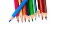 Blue colored pencil crayons placed on top of a row of pencils on a paper Royalty Free Stock Photo