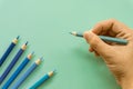 Blue colored pencil One single object, top view, bright tint. Wooden hexagonal barrel, without eraser. H