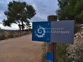 Blue colored signpost at the entrance of Calanques National Park at the French Riviera. Focus on sign.