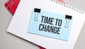 Blue colored stick with text time to change on the white and red notepad Royalty Free Stock Photo