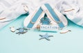 Blue colored summer and holiday background, flippers, sea stars and a glass bootle with the word vacation, travel and tourism Royalty Free Stock Photo