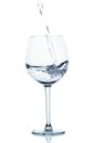 Blue colored water is pouring into the wine glass. Royalty Free Stock Photo