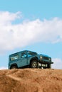 Blue colored 4x4 Suv Car on sand and blue background Royalty Free Stock Photo