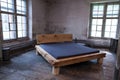 Blue comfortable mattress on a wooden frame.