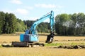 Blue Compact Excavator at Work Royalty Free Stock Photo